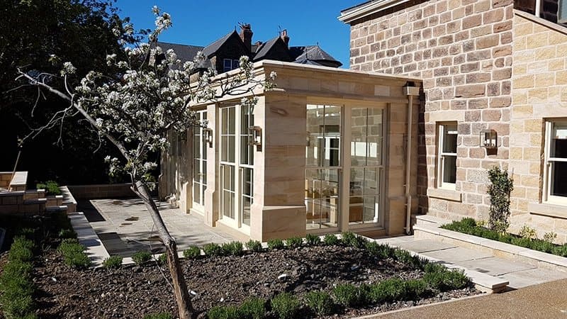 Stone-and-glass orangery seen from the garden